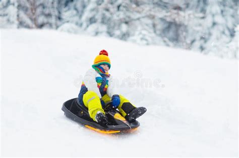 Boy On Sled Ride Child Sledding Kid On Sledge Stock Photo Image Of
