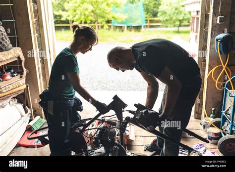 Mature man repairing motorbike hi-res stock photography and images - Alamy