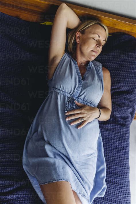Mature Pregnant Women Napping On Bed Stock Photo