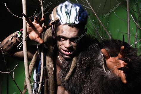 Werewolf With Long Nails And Crooked Teeth Among The Branches Of