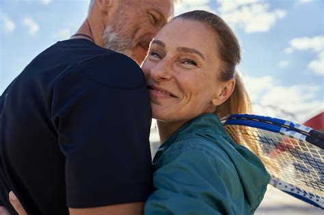 Premium Photo Portrait Of Active Mature Couple Looking Happy While Embracing Each Other