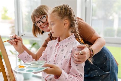 Mature Teacher Talking With Her Pupil During Class In Art School Stock Photo Image Of Pupil