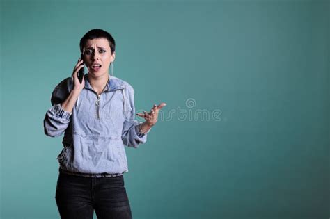 Brunette Woman With Short Hair Using Smartphone To Have Remote Conversation With Friend Standing