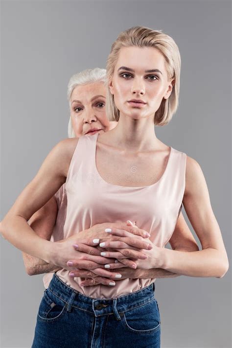 Serious Blonde Girl Crossing Hands And Fingers With Her Senior Mother Stock Image Image Of