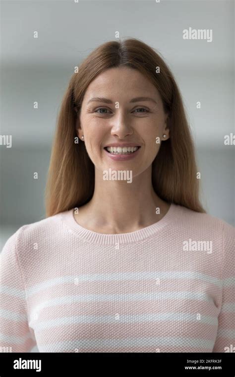 Vertical shot beautiful young woman smile staring at camera Stock Photo