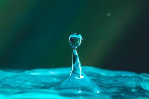 Premium Photo Water Droplets Fall Down Closely Into The Dark Blue