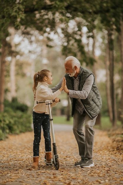 Premium Photo Senior Man Teaching His Granddaughter How To Ride Kick