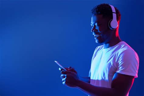 Premium Photo Happy Millennial Black Guy In Wireless Headphones Using