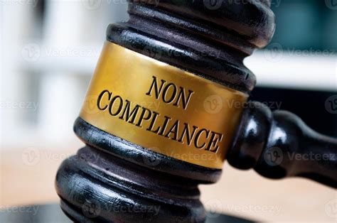 Non Compliance text engraved on lawyer gavel. Law and compliance