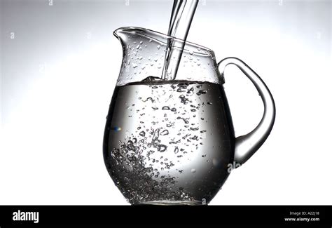 Clear Water Being Poured Into Glass Pitcher Stock Photo Alamy