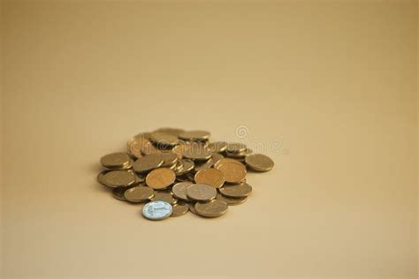 A Lot Of Small Coins Are In A Pile Close Up On A Light Background Stock