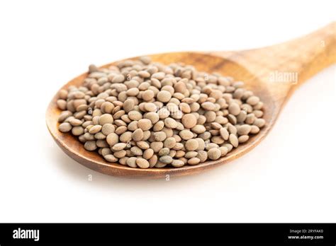 Lentil On Wooden Spoon On White Background Lens Culinaris Stock Photo