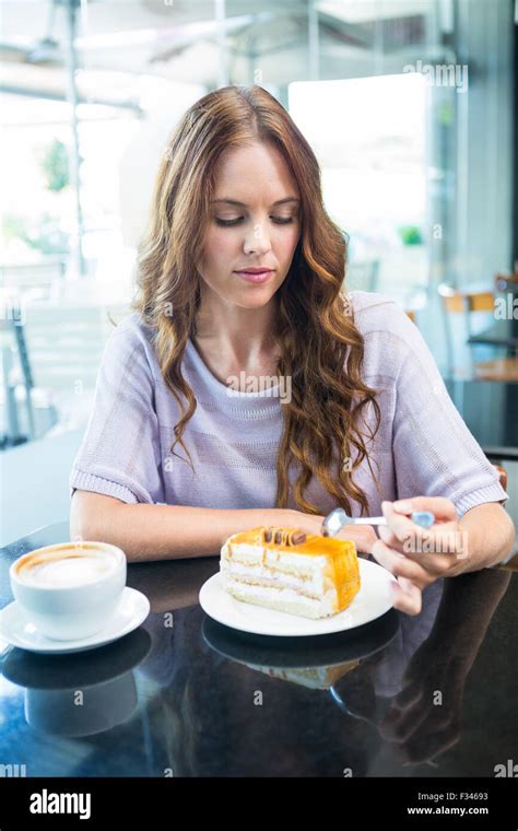 Pretty Brunette Enjoying A Cake Stock Photo Alamy