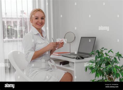 Blonde Doctor In The Doctor S Office Smiling On The Table Is A Computer A Mirror The Office