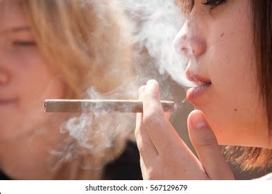 Two Girls Smoking Brunette Smokes Cigar Stock Photo Edit Now