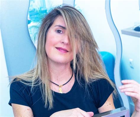 Lady Shows Off Her Long Blonde Hair After A Makeover At The Hair Salon