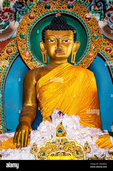 Huge Buddha Golden Statue Decorated With Religious Flags And Offerings