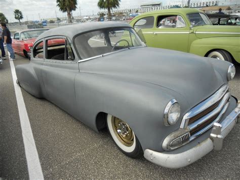 Old Grey Car In A Parking Lot