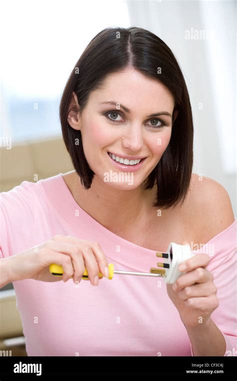Female Short Brunette Hair Wearing Off The Shoulder Pink Top Length Sleeves And Brown Satin