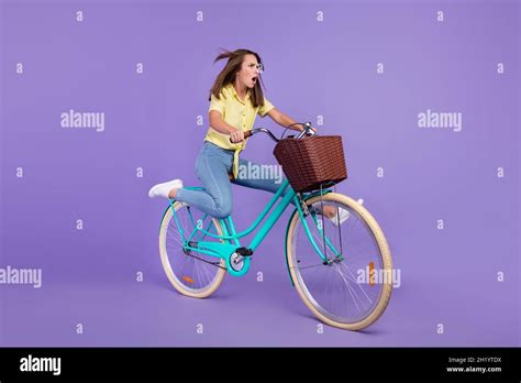 Full Length Profile Photo Of Amazed Millennial Brunette Lady Go Bicycle Wear Yellow Top Jeans