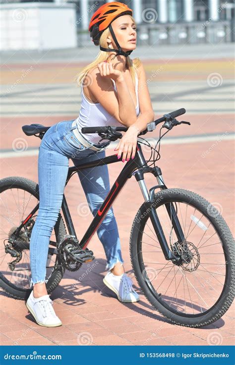 Girl Blonde Girl With Big Tits In Helmet Is Posing Outdoor On The Bicycle Stock Photo Image