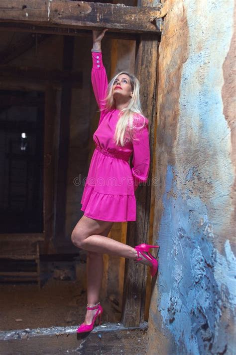 40s Blonde Woman In Pink Dress Looking Up On Timber Leg Up Stock Image Image Of Mature Pink