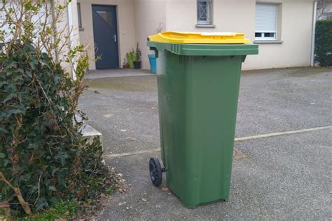 Premium Photo Recycling Bin Green Trash Can With Yellow Lid For