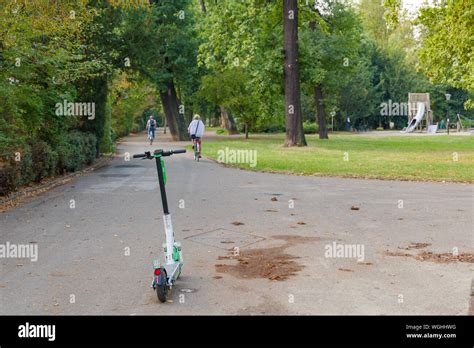 Electric scooters park on walkway at Seilspielplatz park in Düsseldorf ...