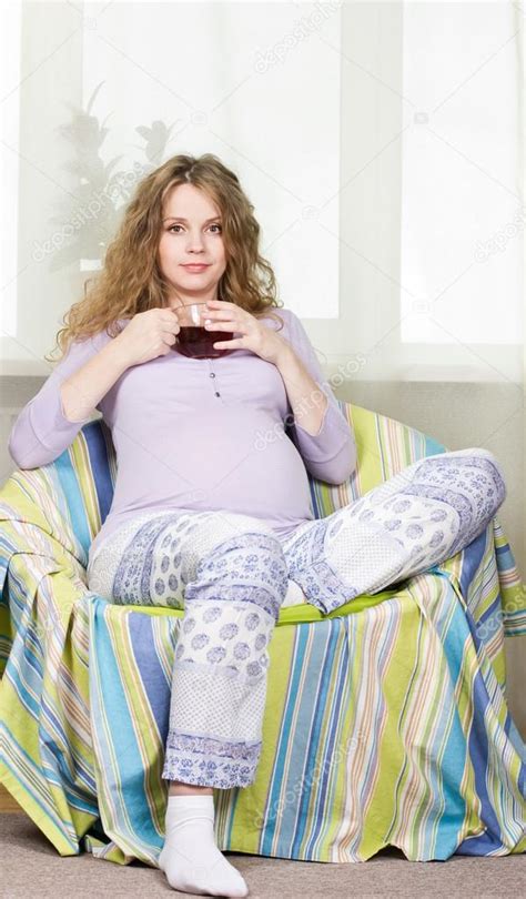 Pregnant Blonde Drinking Tea At Home Portrait Beautiful Pregnant Curly Blonde Stock Photo