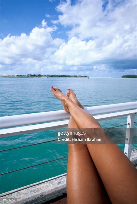 Young Woman Sunbathing On A Boat Cruise Photo - Getty Images