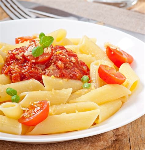 Free Photo | Penne pasta with bolognese sauce, parmesan cheese and basil