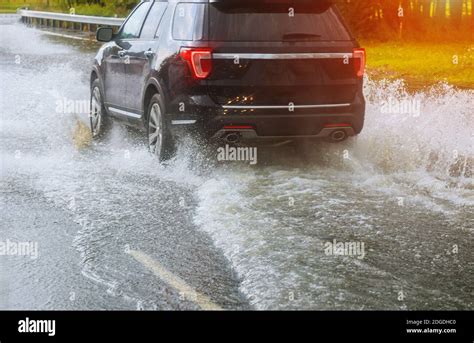 Cars Driving On A Flooded Road During A Flood Caused By Heavy Rain