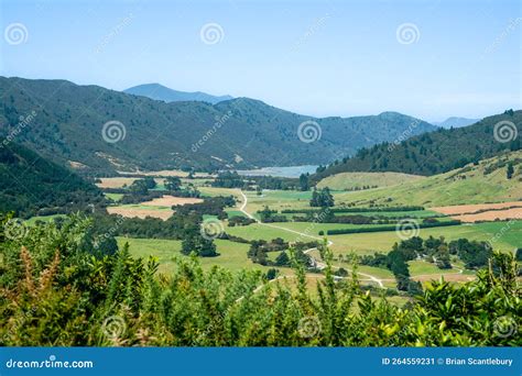 Rural Dirt Road Leading Through Valley To Distant Bay Stock Image