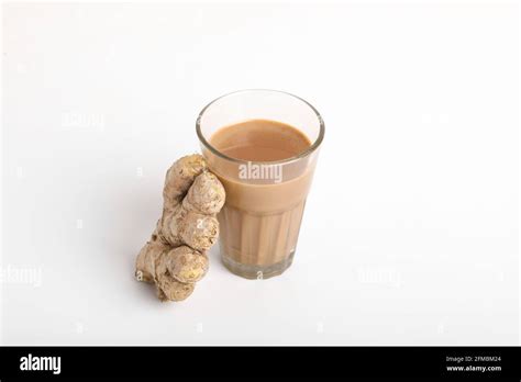 Glass Cup Of Hot Ginger Tea With Ginger Rhizome Root Sliced Isolated On White Background Stock