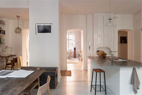 Warm minimalism and a white farmhouse kitchen in a light-flooded ...