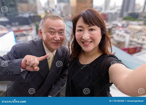 Mature Asian Businessman And Mature Asian Woman Exploring The City Together Stock Photo Image