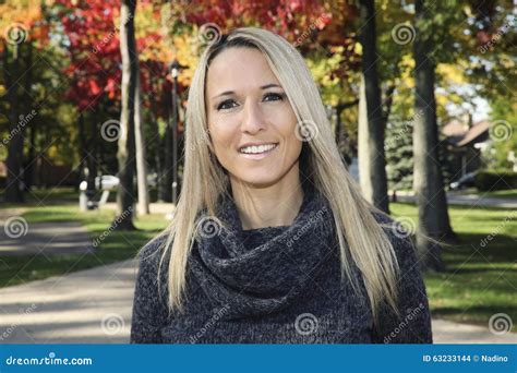 Portrait Of A Mature Woman Smiling At The Camera Stock Photo Image Of Green Camera