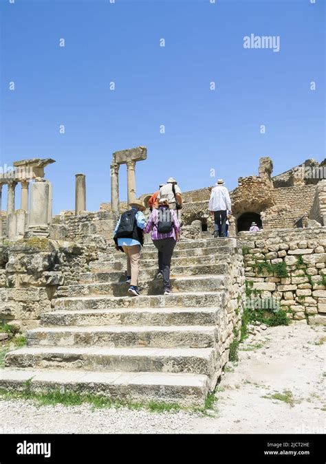 Tourists Entering Dougga Ruins to Explore Ancient Roman City Stock Photo - Alamy