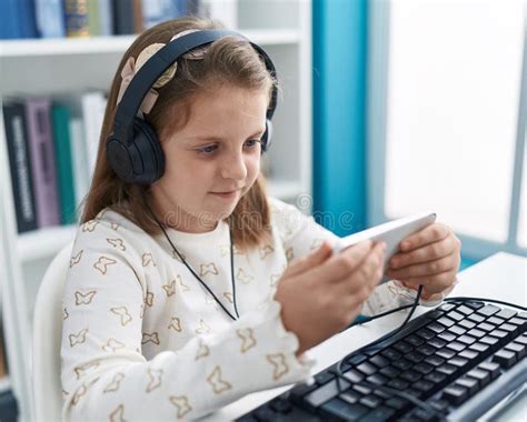 Adorable Blonde Girl Student Watching Video On Smartphone At Classroom Stock Image Image Of