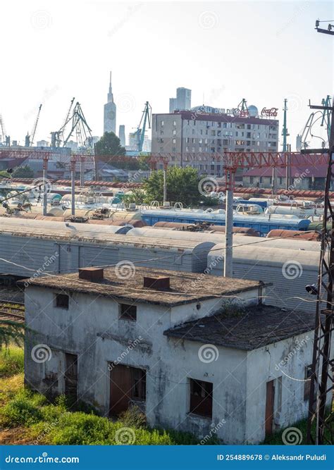 Railroad In The City. Abandoned Scrap. Port Cranes And High-rise