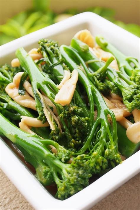 A White Bowl Filled With Broccoli Covered In Sauce