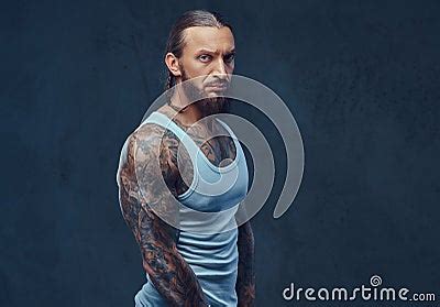 Close Up Portrait Of A Muscular Naked Bearded Tattoed Male With A Stylish Haircut In A