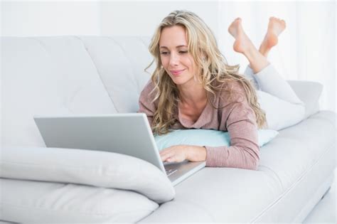 Premium Photo Pretty Blonde Lying On Couch Using Laptop