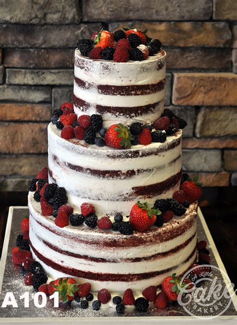 A Naked Wedding Cake With Fresh Fruit