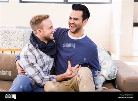 Gay Couple Laughing On The Couch Stock Photo Alamy