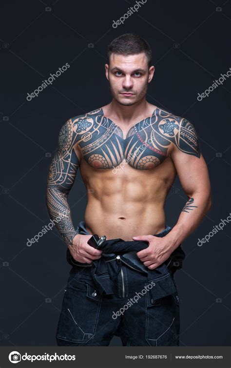 The Man With A Muscular Naked Torso With Tattoos On The Dark Background ABS Stock Photo By