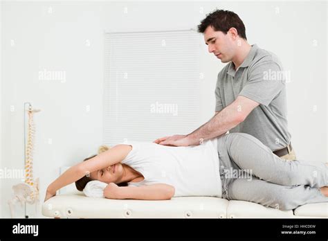 Brunette Woman Lying On The Side While Being Massaged In A Medical Room Stock Photo Alamy