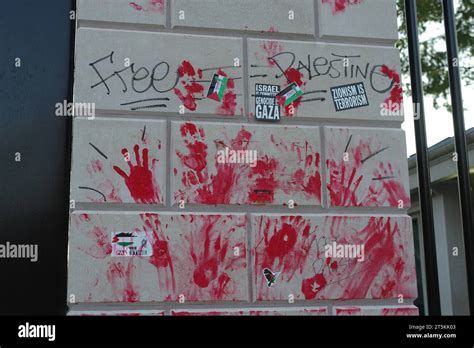 Red Paint Handprints Protest Stickers And Graffiti Remain On A Wall