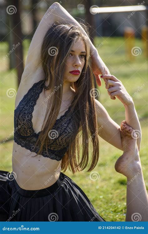 Girl Doing Gymnastic Exercises In A Bra And Black Skirt In A Public