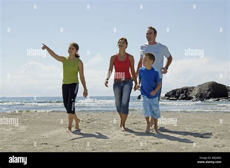 Beach parents children two barefoot walk cheerfully series people Stock ...